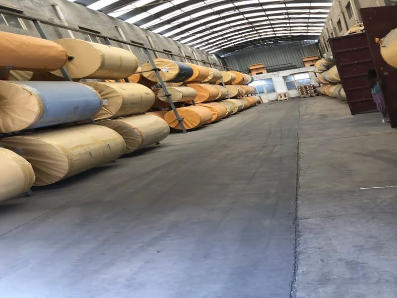 construction worker leveling concrete floor before installing pvc sheets